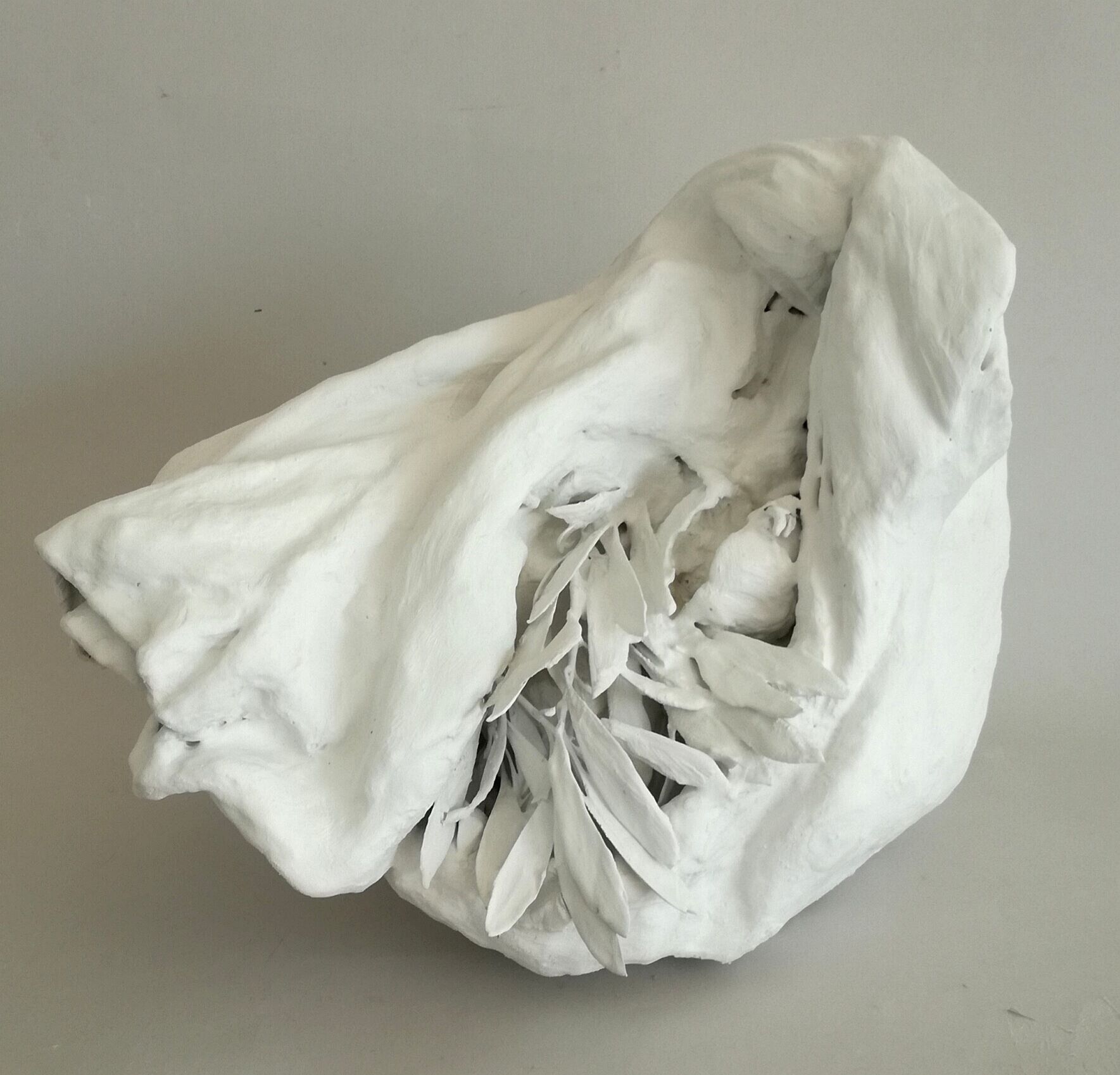 Il dono, 2025 stoffe di cotone, gesso, melograno, rami di ulivo cm 23x10x20